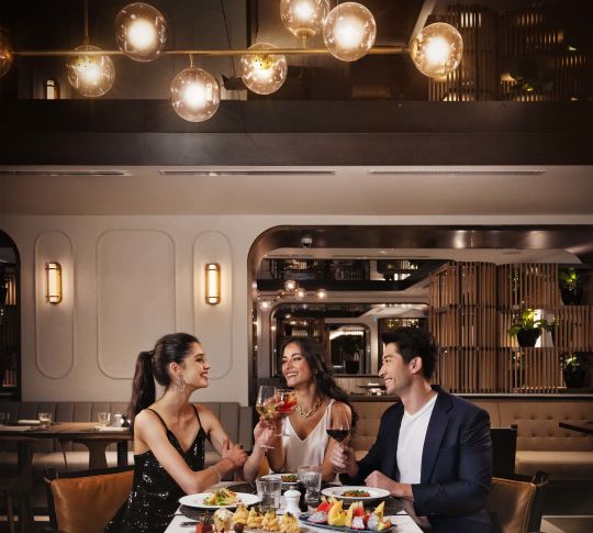 Three people dining at an on site restaurant together
