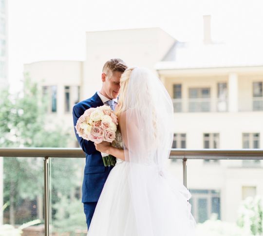 Bride and groom on balcony