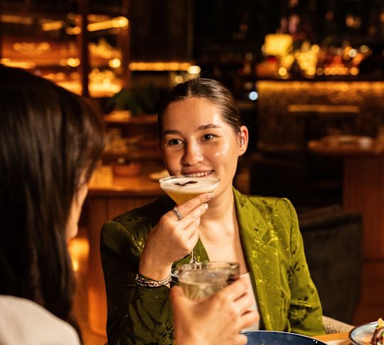 guests having cocktails and dinner at MURU festive eve party