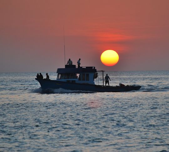 Fishing boat on the ocean at dusk