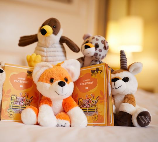 Close-up of stuffed mascots on bed