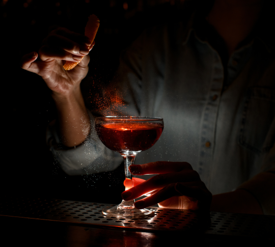 Person preparing cocktail
