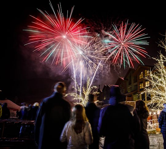 People Watching Fireworks in a City at Night