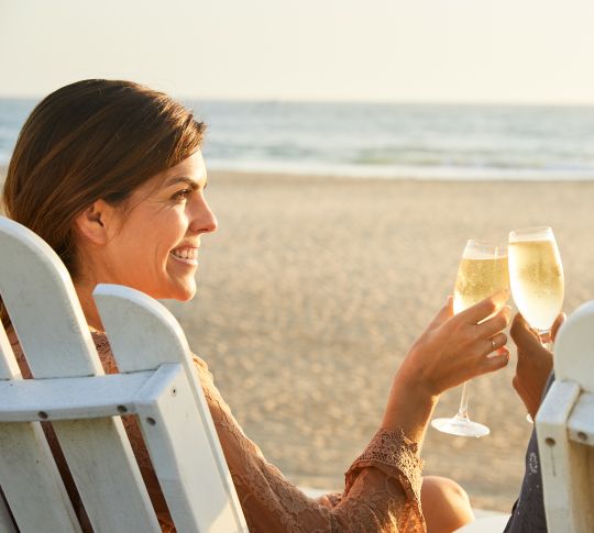 Couple Sitting and Enjoying Drinks at the Beach