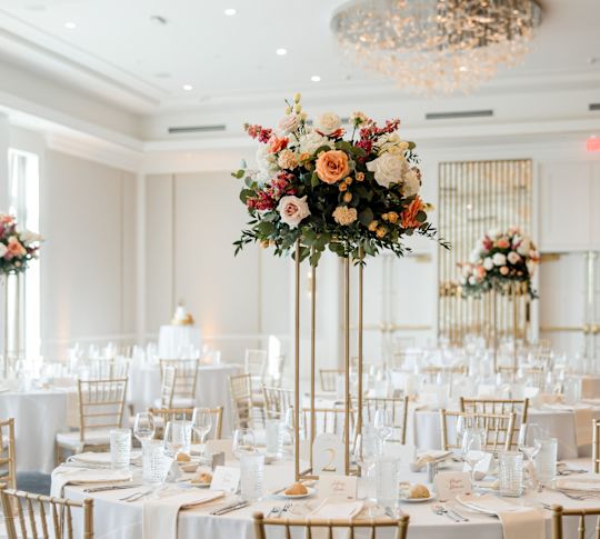 Table Decorated with Flower Arrangements in a Ballroom to Celebrate a Wedding