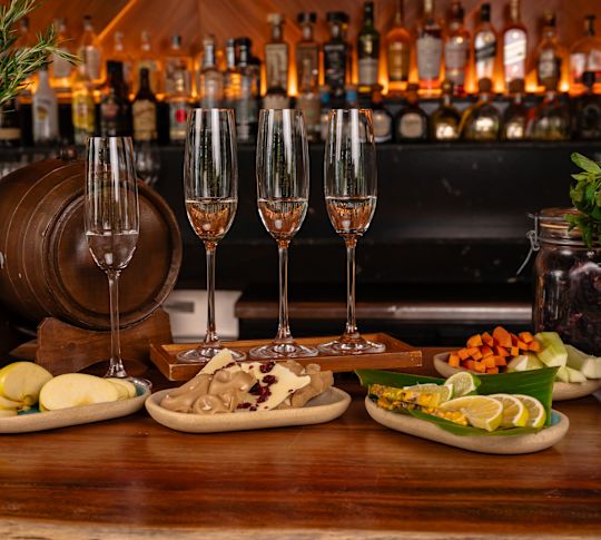 Wine glasses with food lined up on bar