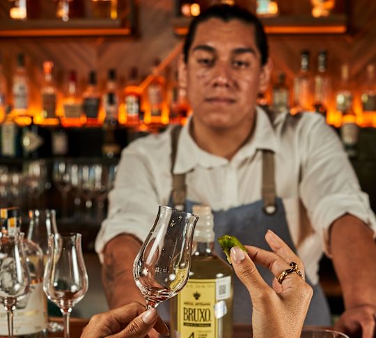 Chaak Bar - Bar tender and woman holding a glass