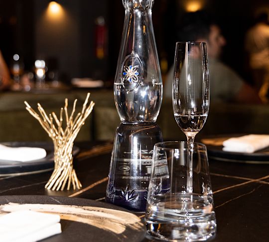 Tequila and glass on table