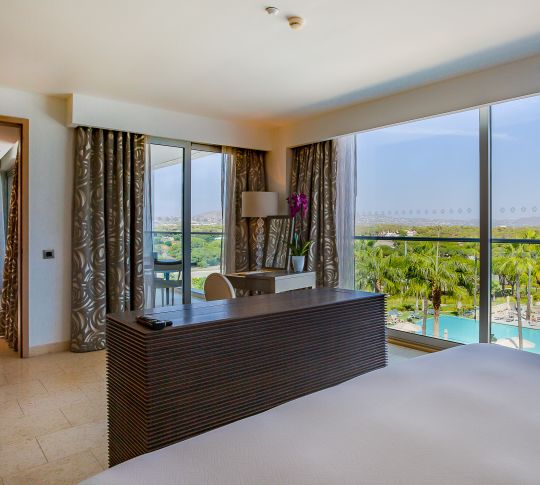Bedroom with Desk Area of Deluxe Suite with Pool View