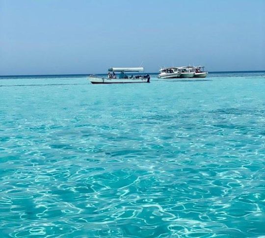 Turquoise water with boats, bright and clear ocean water.