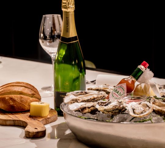 The Coburg Dining Table with Champagne, Bread and Oysters