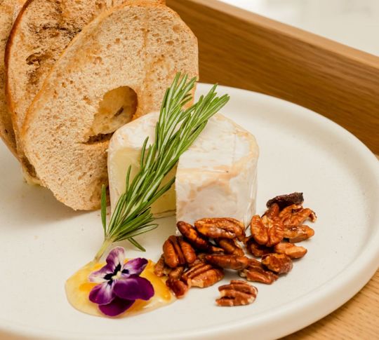 a Plate with Bagels, Cheese, Pecans and a Flower