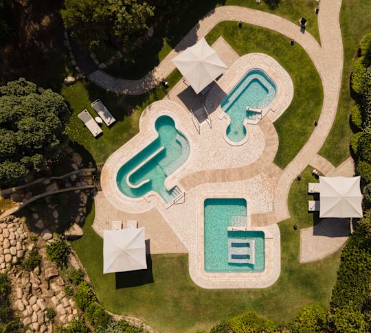 Aerial View of Three Outdoor Swimming Pools at the Spa-transition
