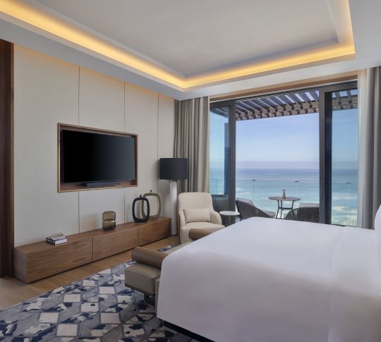 Large Bed Armchair and HDTV in Royal Suite with Ocean View from Terrace