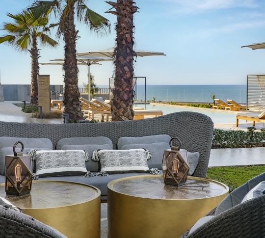 Comfortable Seats at a Restaurants Terrace with Pool and Ocean View
