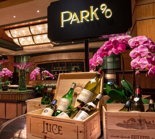 Selection of wines displayed in crates in front of Park90 wine bar sign