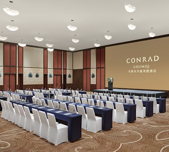 Ballroom with tables, chairs and projector screen