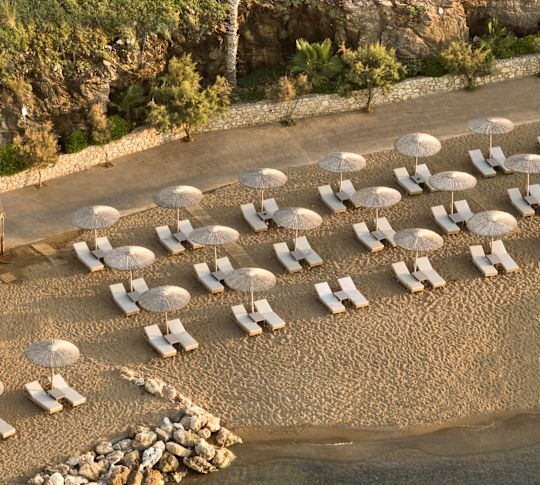 Lounge Chairs under Umbrellas on a Private Beach
