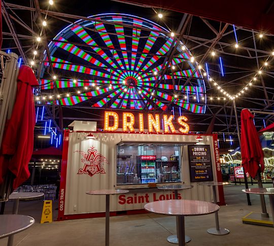 concession stand and farris wheel in background