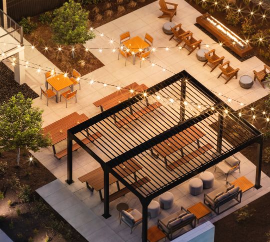 Aerial View of Spacious Outdoor Beer Garden, featuring Fire Pit and String Lights