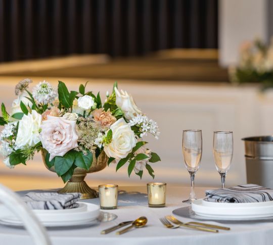 Beautiful detail of table with wedding setup, flowers and champagne.