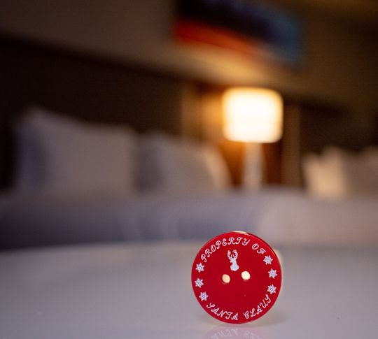 a picture of a red button that says property of Santa Clause
