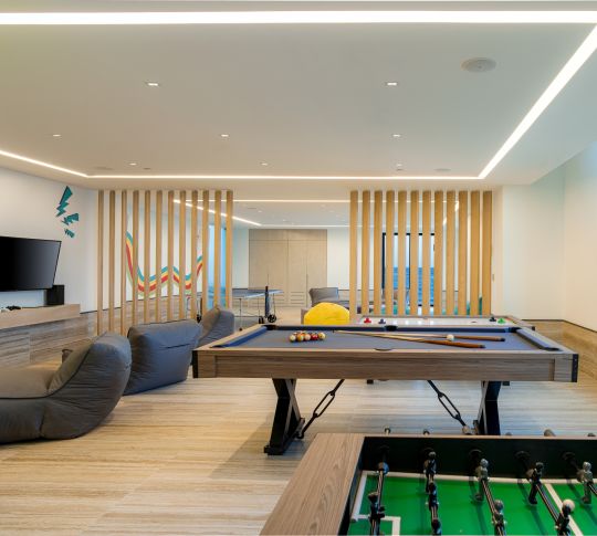 indoor game center with billiards and gaming console