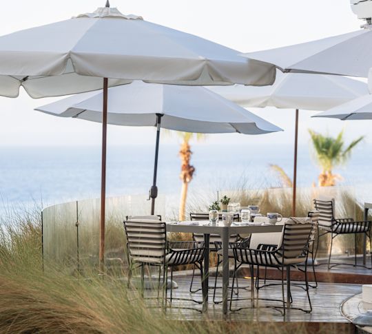 outdoor dining tables overlooking beach