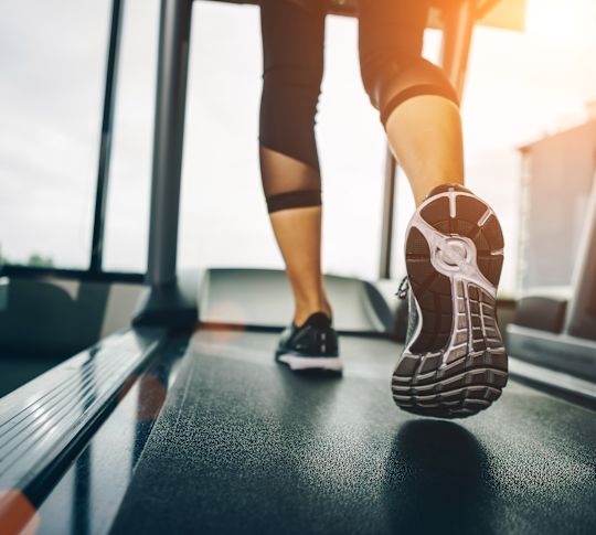 Closeup of woman's legs on a treadmill