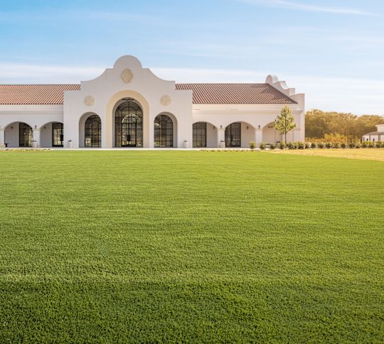 Exterior View of The Calera Meeting Venue with a Large Field in Front-transition