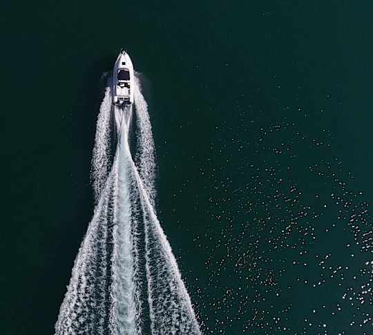 Aerial view of a boat and its wake.