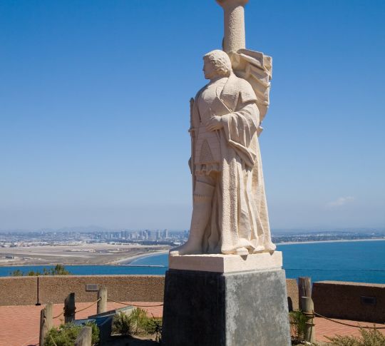 A statue of the explorer Cabrillo looks on toward San Diego