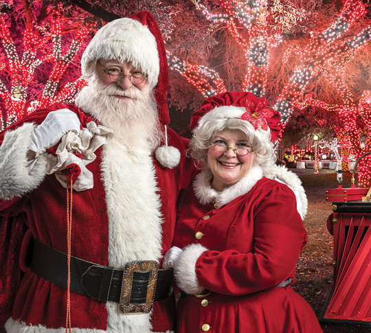 Image of Santa and Mrs. Claus with train and conductor in background