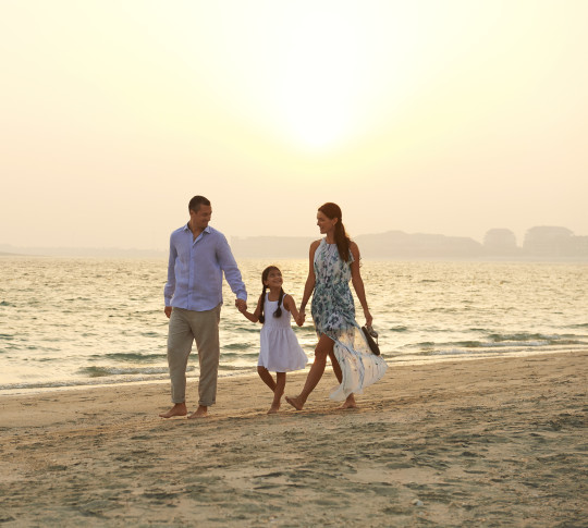 Family Walking On Beach