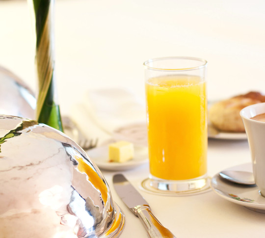 Close Up of Glass of Orange Juice on Dining Table