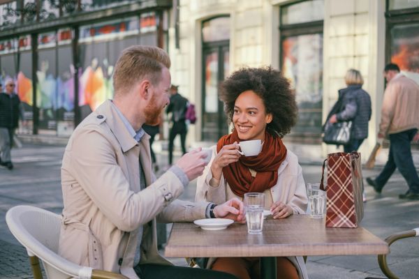 Happy couple having a coffee in the city