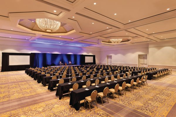 large ballroom with rows of tables and chairs