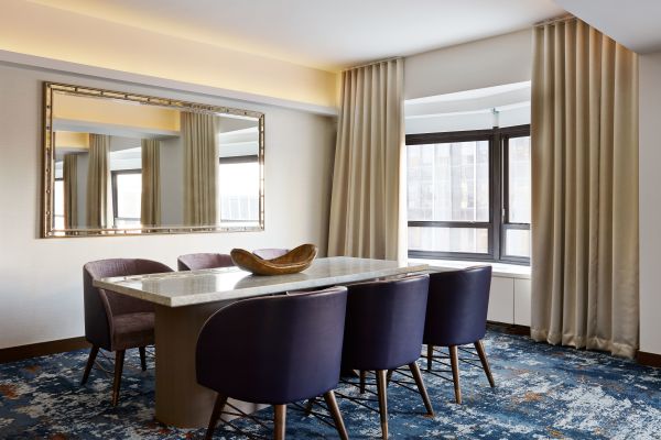 Guest Suite Lounge Area with Dining Table and Armchairs