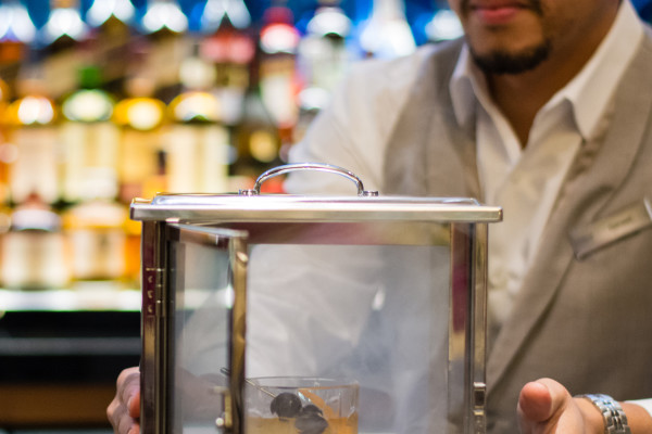 Bartender Holding Case with Cocktail Drink inside steaming