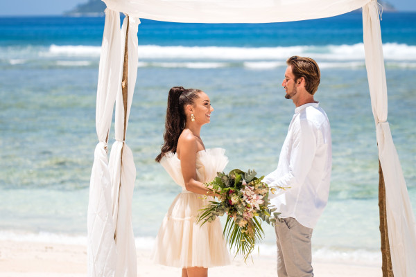 Couple Celebrating a Wedding at the Beach