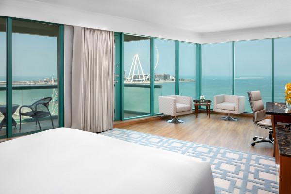 Sea View from Suite with Large Bed Balcony Work Desk and Seating Area