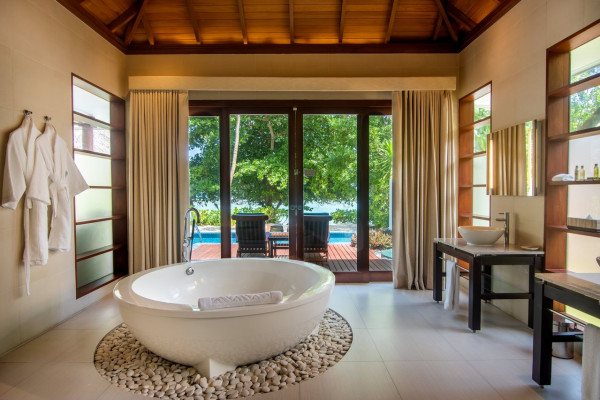 Bathroom with Bathtub and View of Patio Area with Pool