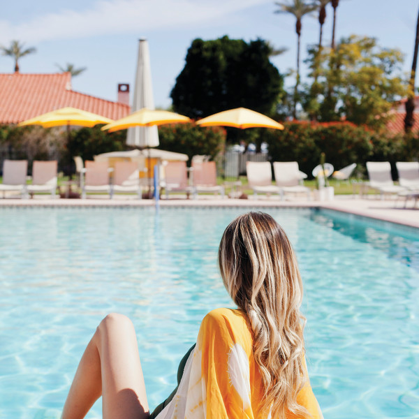 Woman relaxing by pool