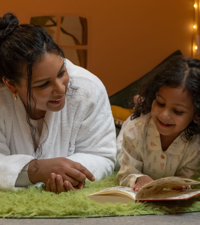 Mum and child reading in bed