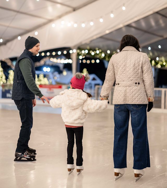 Family Having Fun Ice Skating during the Holidays