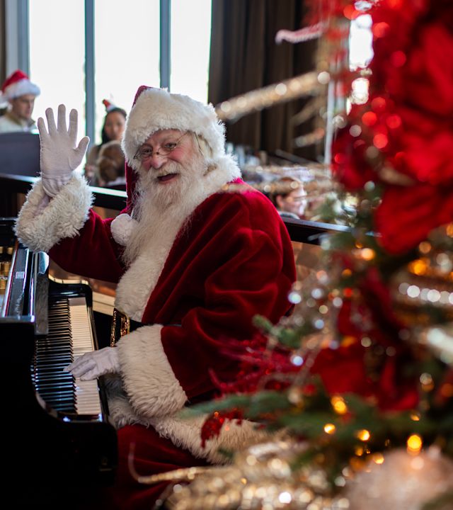 Santa Clauses Playing Piano at a Christmas Celebration