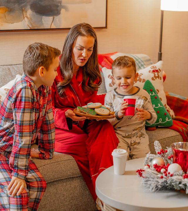 Mother and Sons in a Suite Living Area Decorated for Christmas Celebration