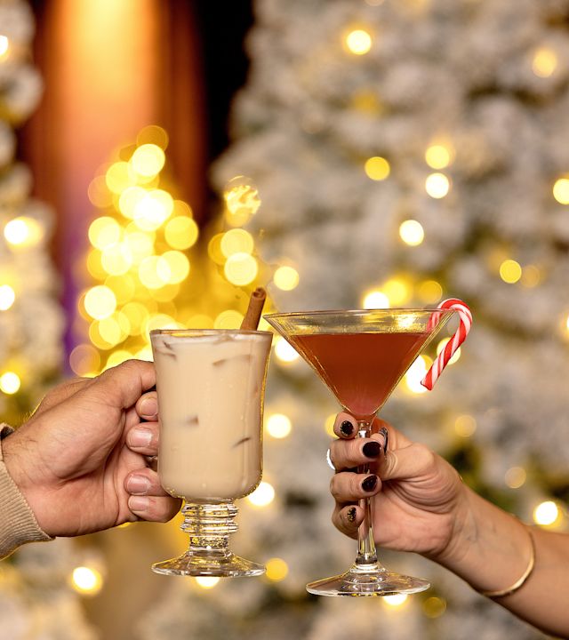 Hands Holding Drinks to Celebrate the Holidays