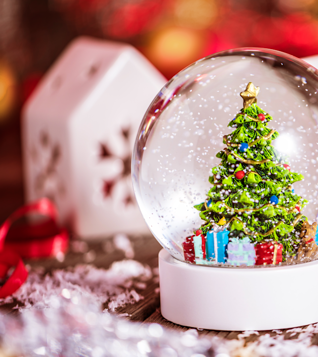 a Christmas Snow Globe and Other Decorations on a Table