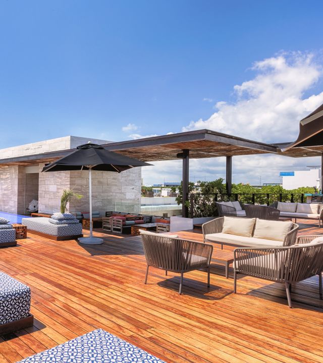 Rooftop outdoor pool area with seating and loungers